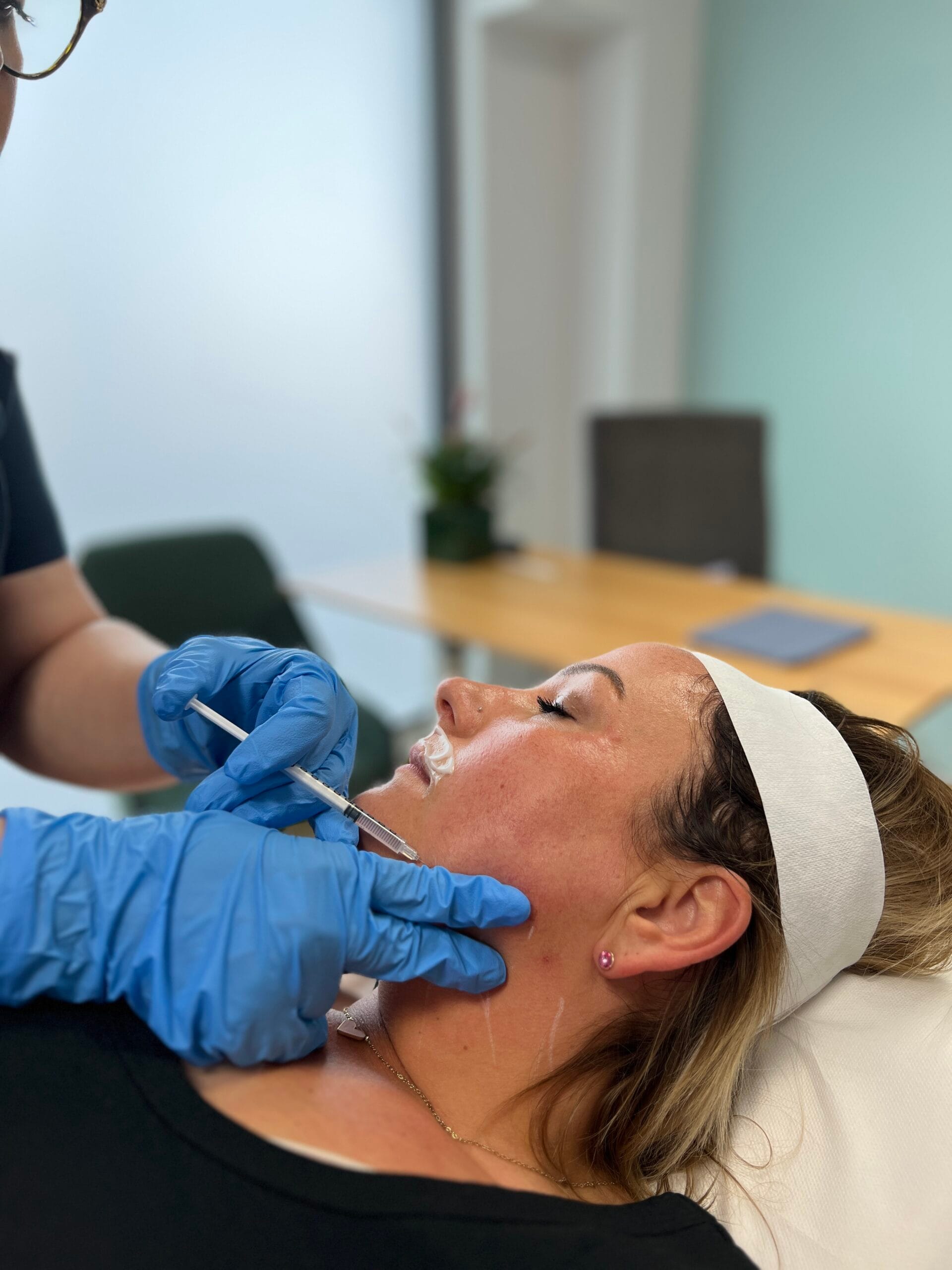 A clinician performing a lower-face aesthetic injection at KONCEPT Medical Clinic, Kingston upon Thames.